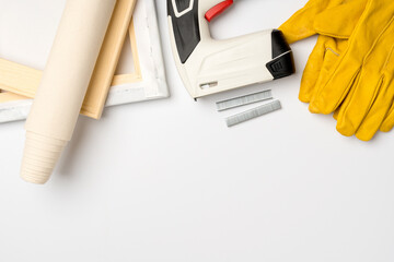 Tools for stretching canvas on a wooden frame in the frame workshop top view. The business of printing photos on canvas, copy space