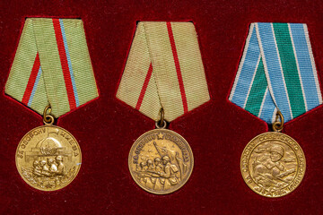 Soviet military medals of World War II on red background