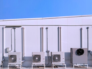 Group of air conditioner compressors with ventilation equipment and pipe lines system outside of...
