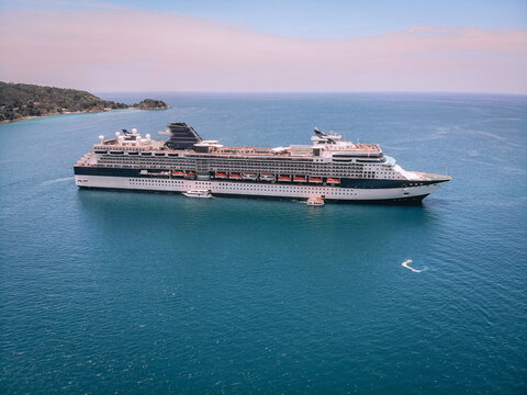 White cruise ship, blue seascape, horizon and sky, drone view shot.