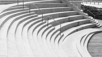 Amphitheater Arena Arts Acting Venue for Entertainment concrete seats steps outdoors beach empty in black and white landscape.