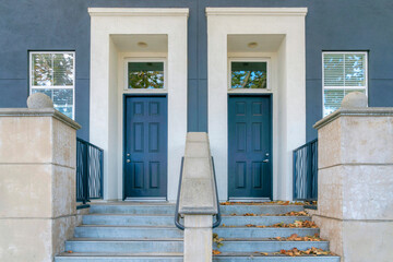 Two blue front doors with white doorframes and transom windows at San Jose bay area, California