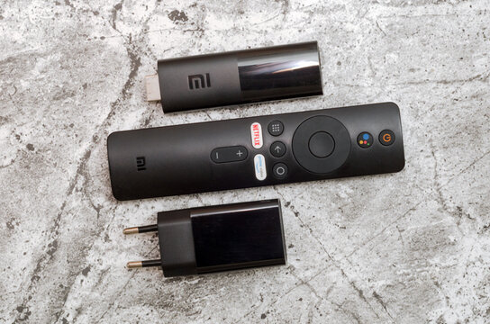 Russia, Irkutsk region, February 7, 2022: MI tv box and remote control with charger on an abstract gray background