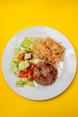 grilled hamburger with salad and salted salas cabbage withcarrot on white plate