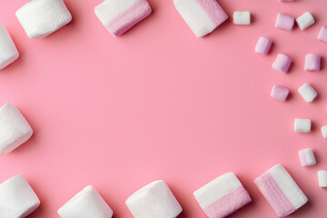 Fluffy marshmallows on pink studio background, top view