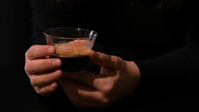 cup of espresso in the hands of a woman. close-up. Dark photo. Close-up. High quality 4k footage