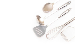 Set of metal kitchen utensils isolated on white background with copy space. Stainless steel kitchen appliances.