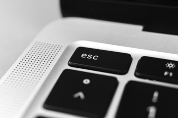 Esc key and button on keyboard. Escape sign close-up. Modern laptop, communication concept photo