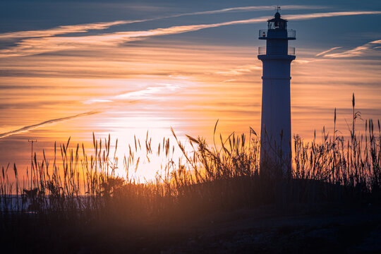 View of the lighthouse of Torrox at sunset, is a lighthouse that is located on the coast of the municipality of Torrox, Malaga, Andalusia, Spain.