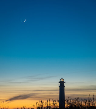 View of the lighthouse of Torrox at sunset, is a lighthouse that is located on the coast of the municipality of Torrox, Malaga, Andalusia, Spain.