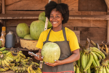 portrait of an african market woman holding a watermelon