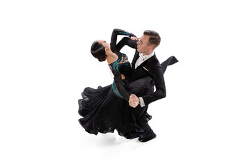 Viennese waltz. Young graceful artistic couple, man and woman dancing ballroom dance isolated over white studio background. Beauty, art, sport concept