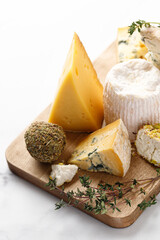 Shropshire, langre, asiago, gorgonzola, shanklish cheese on wooden board.