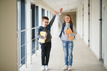 Fototapeta premium School kids in uniform together in corridor. Conception of education.