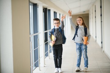 Happy school kids in corridor at school