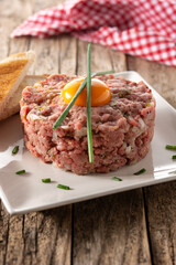 Beef steak tartare on rustic wooden table