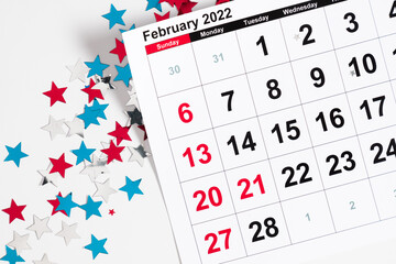 Presidents Day. Date on calendar February 21, 2022. Red, blue and white star confetti, decorations...