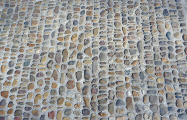 Walking path paved with round sea stone outside in the garden in Madrid, Spain