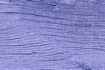 Trendy very peri color of the year 2022, violet weathered wooden background with cracked paint