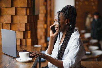 Professional African american copywriter talking about new project on mobile earning money...