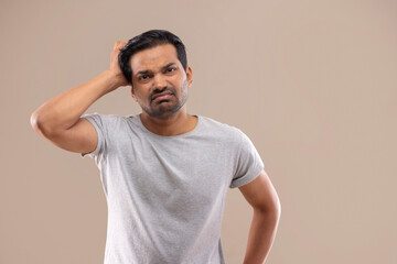 Portrait of a frustrated young man with hand on his head