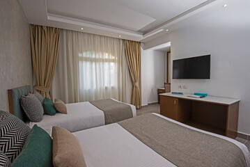 Twin beds in suite of a luxury hotel room