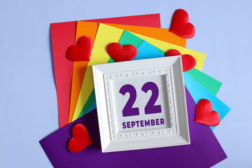 day of the month 22 September calendar .    Calendar date in a white frame on a rainbow background