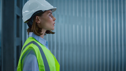 Portrait storage employee walking in manufacture supply complex managing stock