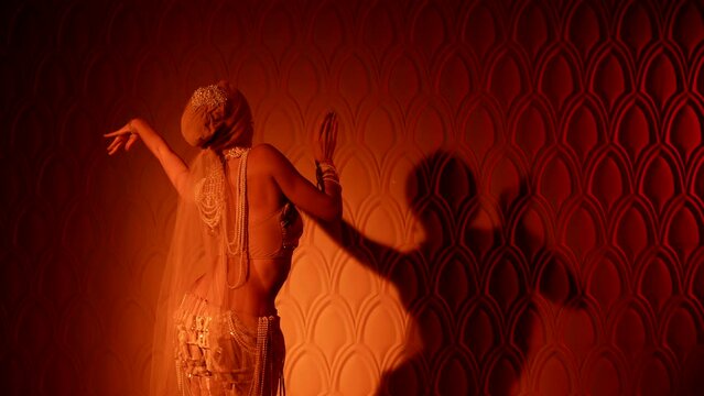 amazing belly dancer is moving in darkness in harem of sultan in palace, traditional oriental dance
