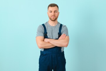 Fototapeta premium Handsome young craftsman over isolated blue background