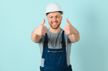 Craftsmen or electrician man over isolated blue background giving a thumbs up gesture