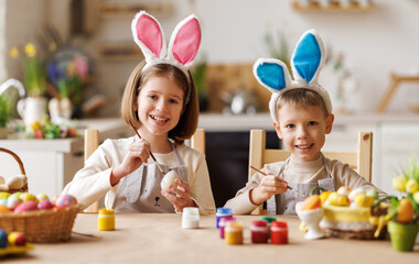 Happy easter! funny children with ears are getting ready for holiday