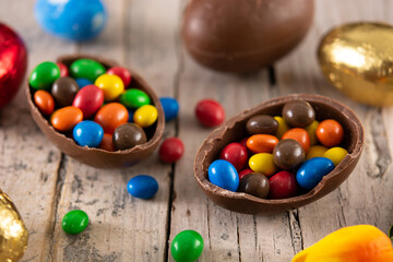 Fototapeta na wymiar Colorful chocolate Easter eggs on wooden table