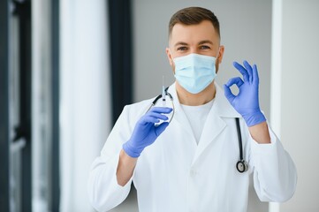 Fototapeta na wymiar Portrait of male doctor wearing surgical mask is ready to help patients with coronavirus or covid virus.