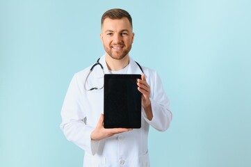 closeup of showing a tablet holding in hands by a male doctor who has a pretty smiley.