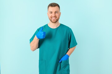 Horizontal banner of smiling young doctor ready to help patients with health problems, isolated on blue background with copy space.