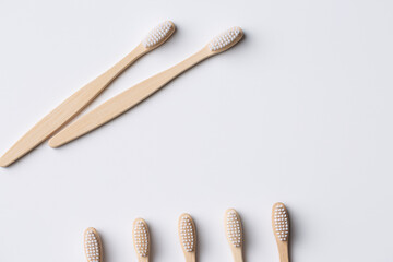 Set of ECO friendly wooden bamboo toothbrushes. Save the planet or NO plastic concept. Isolated on white background.