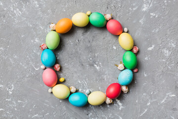 round frame Multi colors Easter eggs on colored background . Pastel color Easter eggs holiday...
