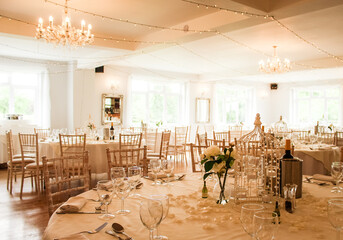 Tables, chairs and cutlery laid out at a wedding venue in Hampshire, UK.