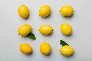 Many fresh ripe lemons as colored background, top view. Elegant background of lemon and lemon slices Top view flat lay