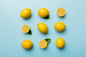 Many fresh ripe lemons as colored background, top view. Elegant background of lemon and lemon slices Top view flat lay