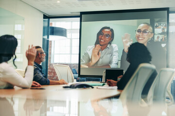 Fototapeta na wymiar Team of colleagues greeting their business associates during a virtual meeting