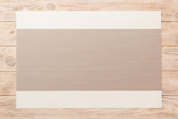 Top view of grey tablecloth for food on wooden background. Empty space for your design