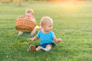 Toddler eggs hunters close-up. Children activity for Easter in nature..