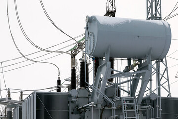 Winter at the substation. High-voltage electrical substation, various electrical equipment for...