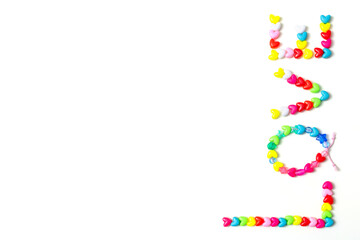 words love from beads of hearts on a white background