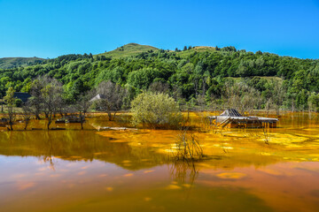 Orange lake of poison from a gold mine pollution