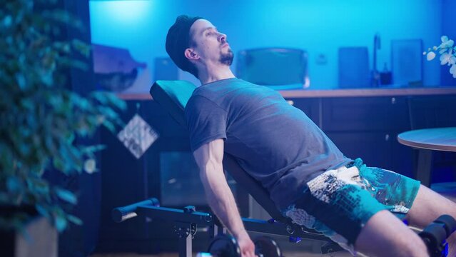 Male person bench biceps side curls exercise at home in kitchen 4K