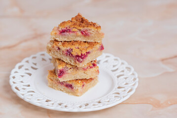 Pile of cake slices with crumbles on a white plate, concept for dessert