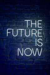 neon glowing inscription on the wall the future is now